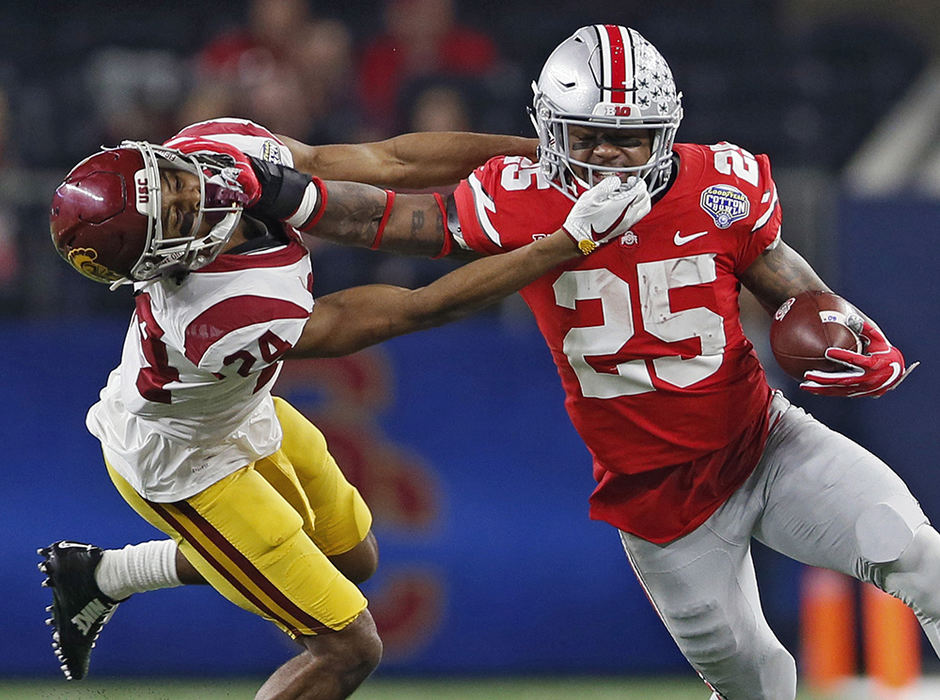 Sports - 3rd place   - Ohio State running back Mike Weber (25) gets a his face mask pulled by USC  cornerback Isaiah Langley (24) during the first half at the Cotton Bowl Classic at AT&T Stadium in Arlington, Texas.  A penalty  was called on Langley. (Kyle Robertson / The Columbus Dispatch)